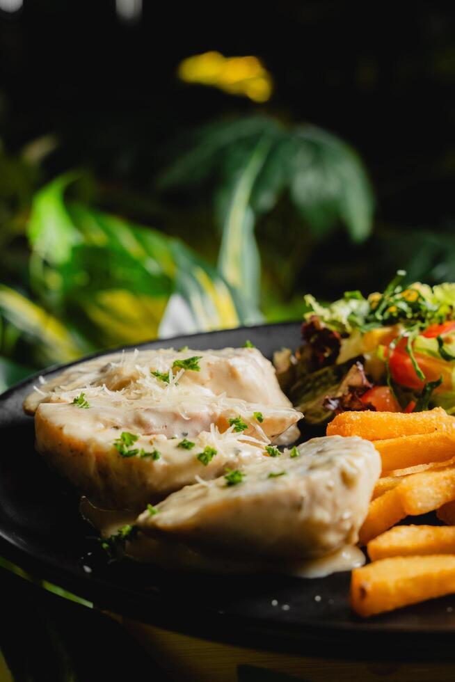 a plate of food with chicken and vegetables on it photo