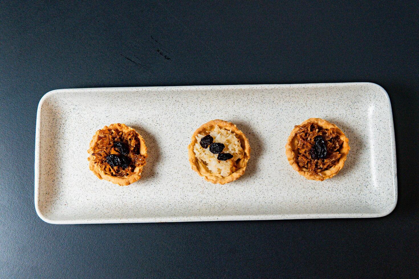 a tray of muffins with one that has the word cranberries on it. photo