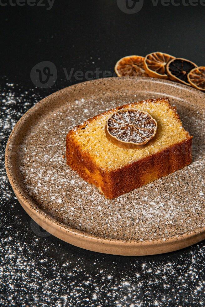 a piece of cake with a slice of lemon on it photo