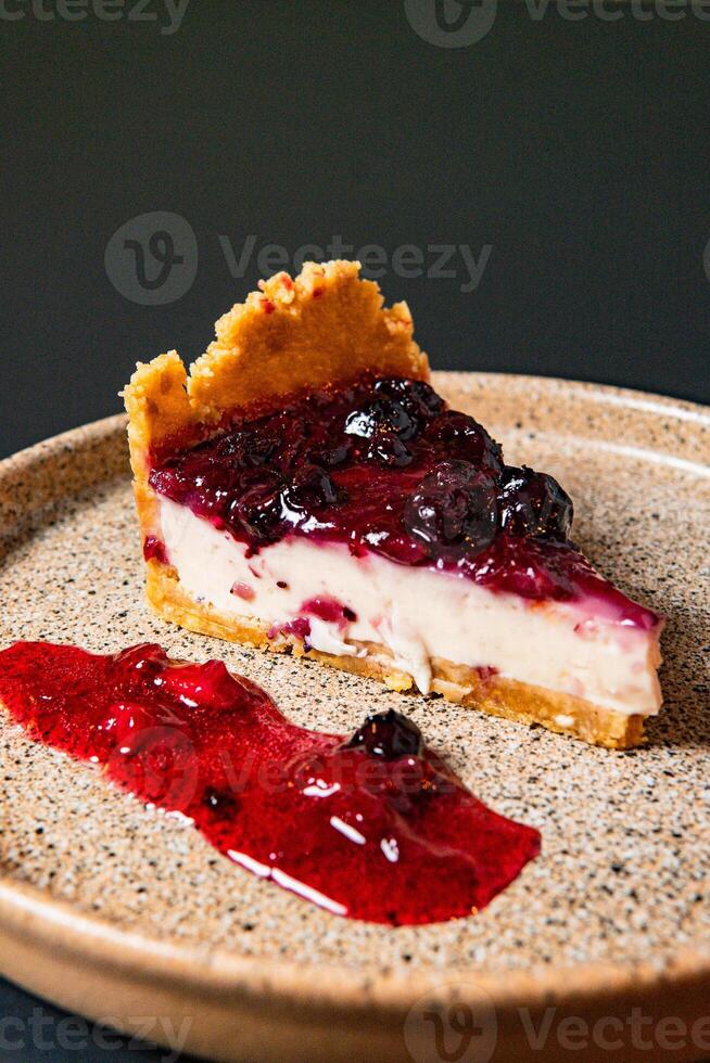 a piece of pie with a blueberry and white topping. photo