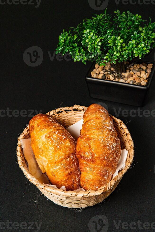 a basket of breads with a plant in the background photo