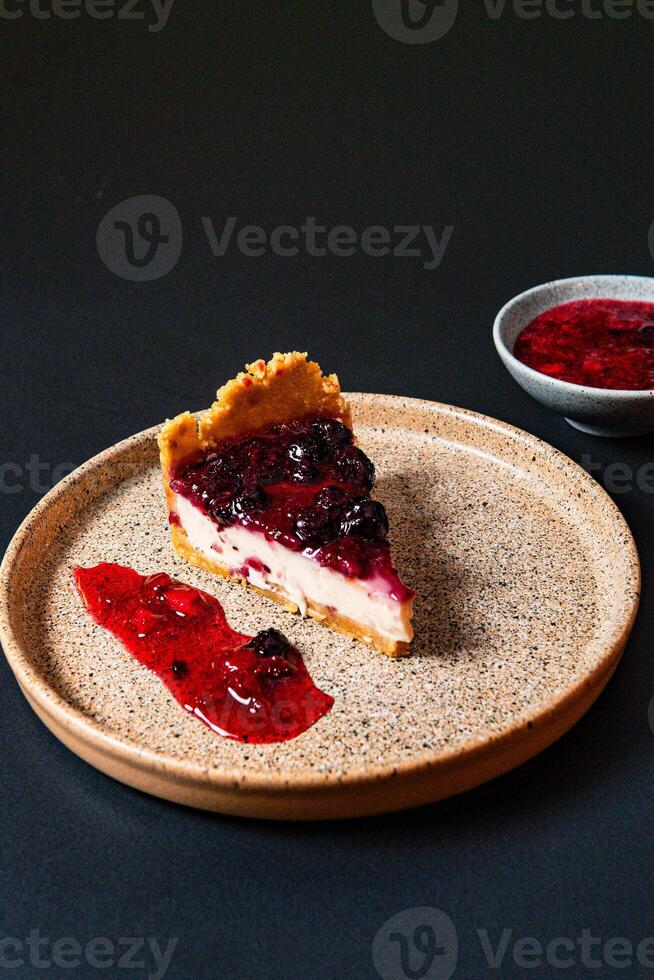 a piece of pie with a blueberry and white topping. photo