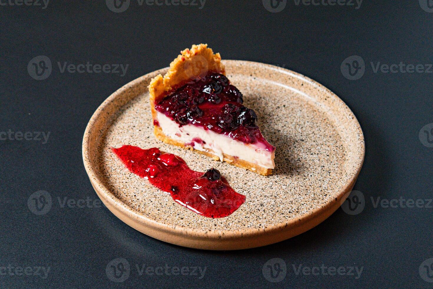 a piece of pie with a blueberry and white topping. photo
