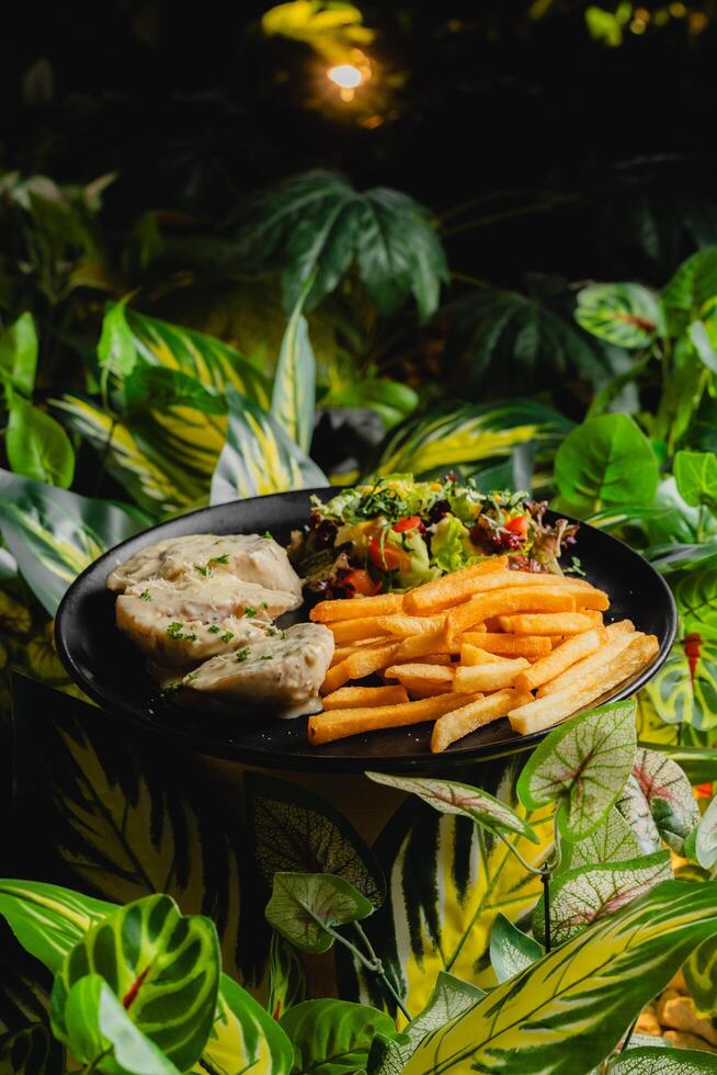 a plate of food with chicken and vegetables on it photo