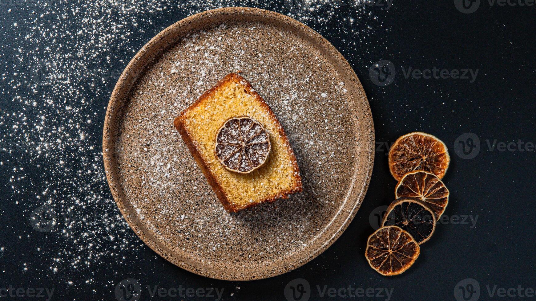 a piece of cake with a slice of lemon on it photo