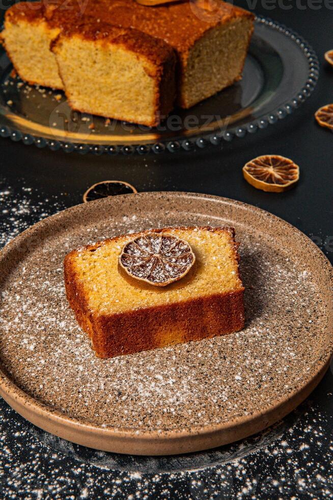 a piece of cake with a slice of lemon on it photo