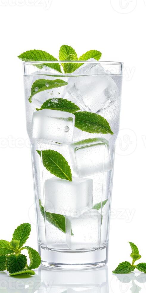 Refreshing mint and ice beverage served in a tall glass with clear bubbles on a bright background photo