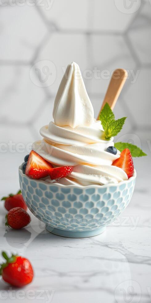 Creamy frozen yogurt topped with fresh fruits and mint in a decorative bowl photo