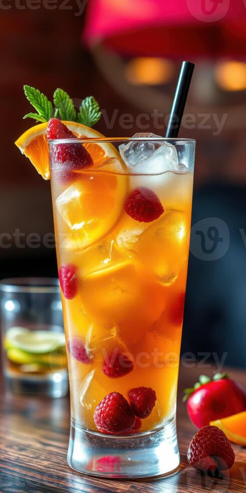 Refreshing summer cocktail featuring raspberries and citrus served in a tall glass with ice photo