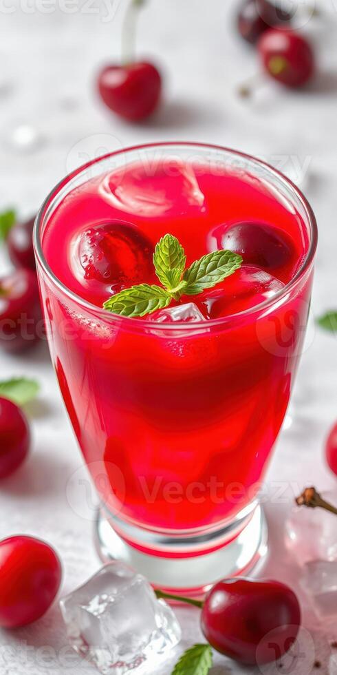 Refreshing cherry drink served in a glass with ice and mint garnish during a warm day photo