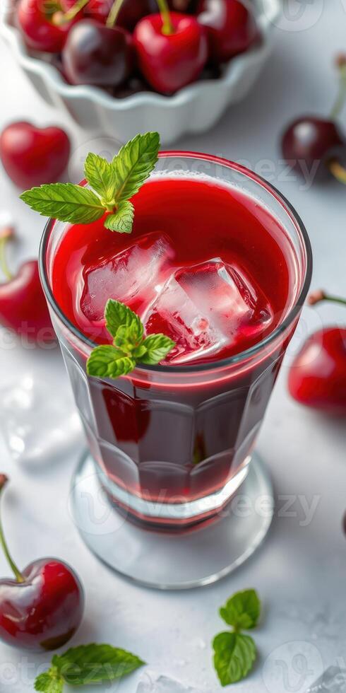 Refreshing cherry drink with ice cubes and mint leaves, perfect for summer enjoyment photo