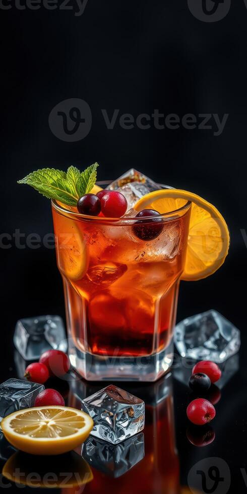 Refreshing cocktail garnished with orange and mint surrounded by ice on a dark background photo