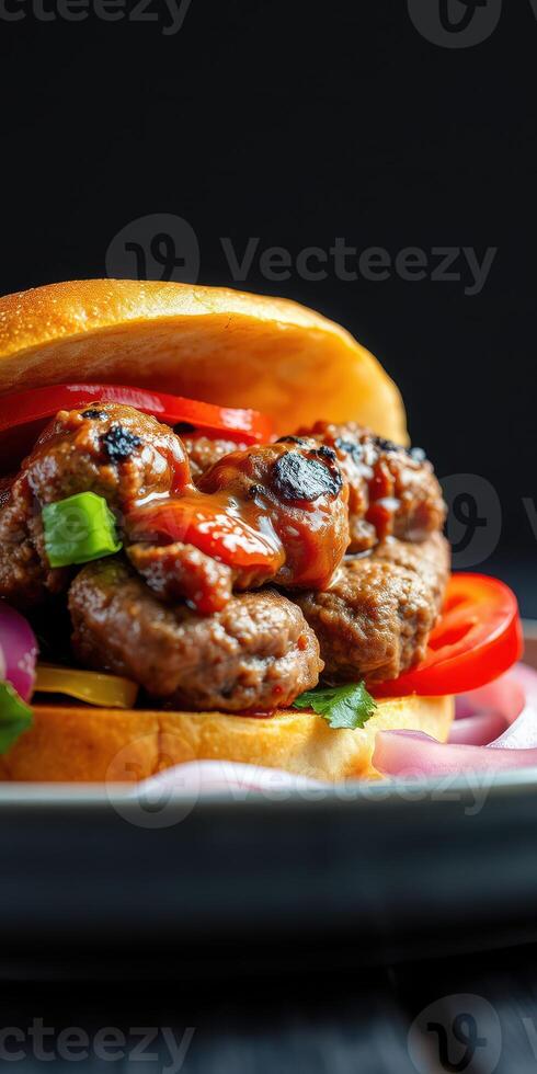 Delicious grilled meat burger with fresh vegetables and sauce on a black background photo