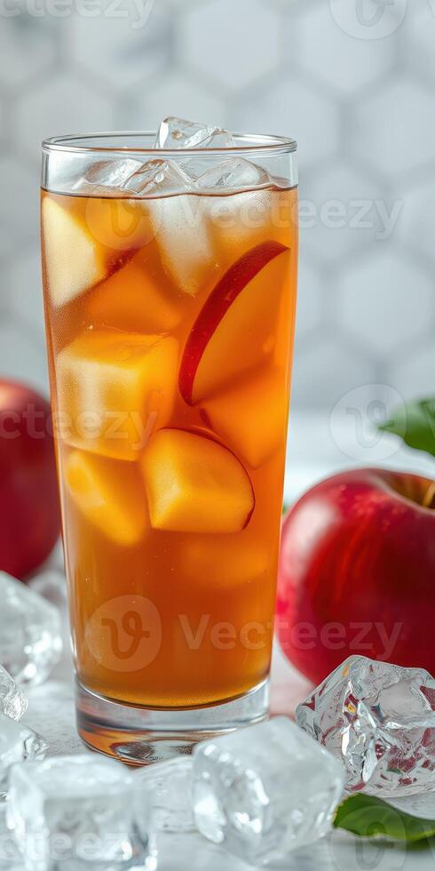 Refreshing iced apple tea with fresh apple slices and ice cubes in a tall glass photo