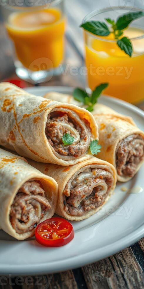 Delicious tortilla rolls filled with savory meat served with fresh herbs and a refreshing drink photo