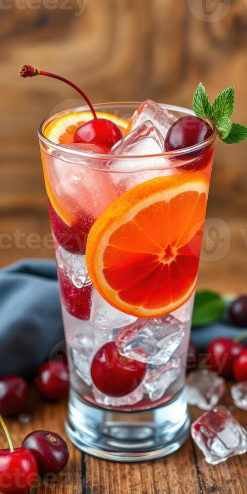 Refreshing cocktail with cherries and orange slices on a wooden table in a cozy setting photo