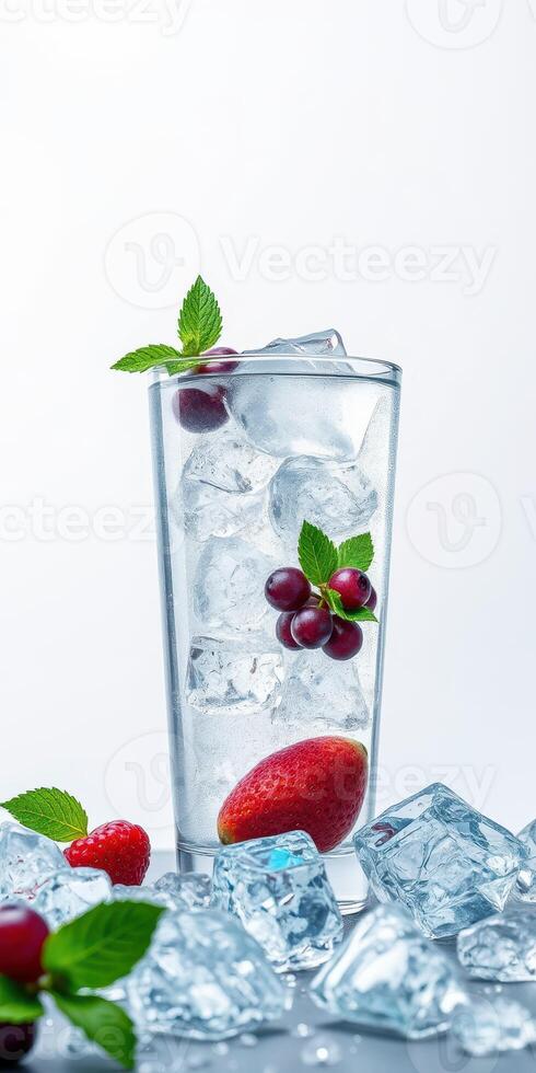 Refreshing drink with ice, strawberries, and mint leaves in a clear glass on a white background photo