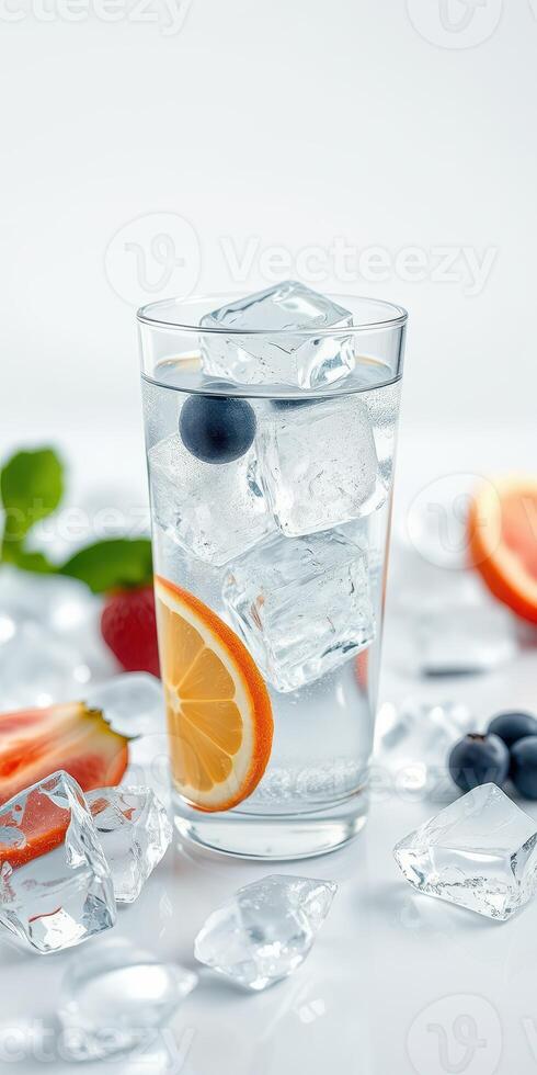 Refreshing summer drink with citrus fruit and ice on a bright background photo