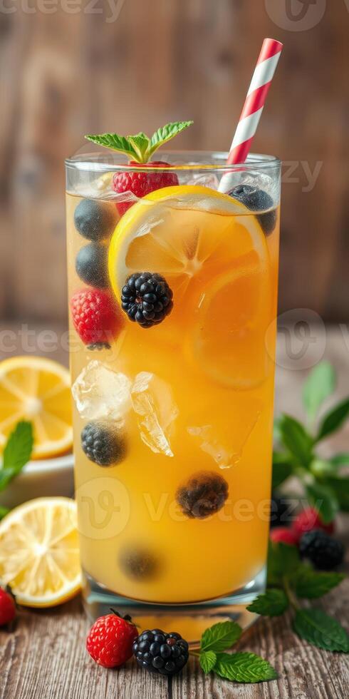 Refreshing summer beverage with citrus and berries served in a tall glass photo