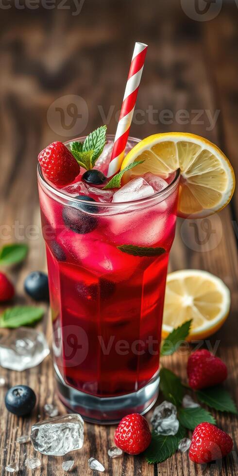 Refreshing berry lemonade drink with mint and ice on rustic wooden table photo