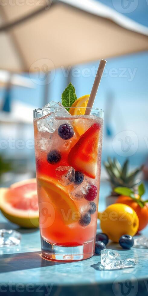 Colorful summer fruit drink garnished with mint served by the beach during a sunny afternoon photo