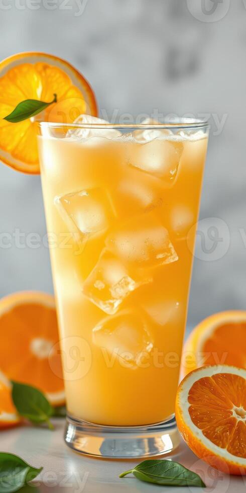 Refreshing orange drink garnished with citrus slices on a marble countertop during a sunny afternoon photo