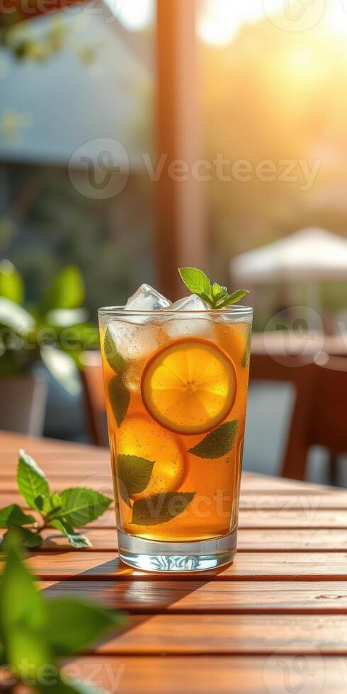 Refreshing iced tea with mint and lemon garnishes served in a bright outdoor setting during golden hour photo