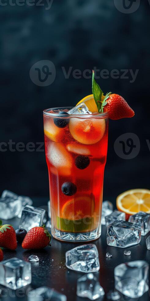 Refreshing summer drink garnished with strawberries and mint on a dark background photo