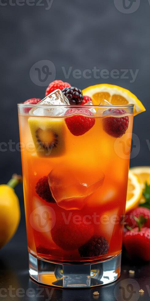 Refreshing fruit cocktail with berries and citrus garnished in a glass on a dark background photo