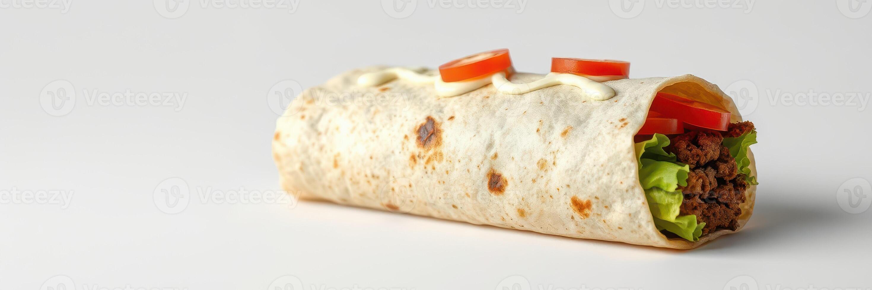 Delicious beef burrito with fresh lettuce and tomato slices served on a plain background photo