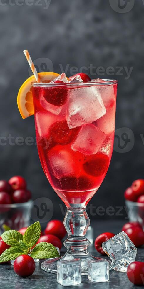 Refreshing cherry drink with ice and citrus garnish on a dark background photo