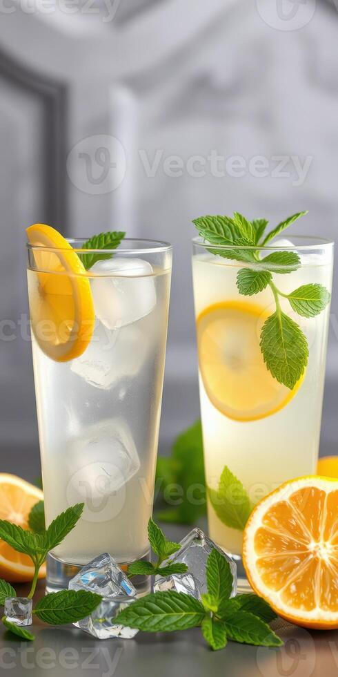 Refreshing citrus drinks with mint and lemon served over ice in a modern setting photo