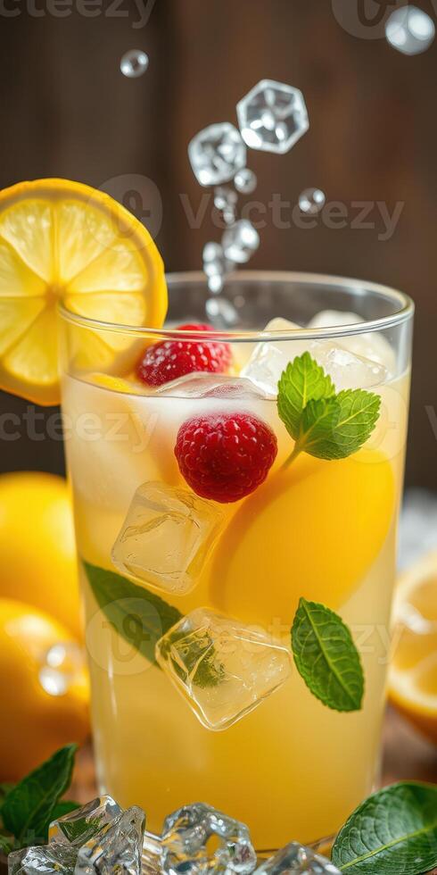 Refreshing lemon drink with mint and berries served in a clear glass on a wooden table photo