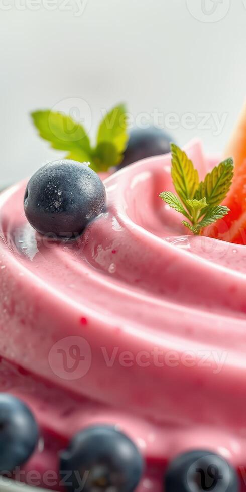 Delicious creamy dessert topped with blueberries and mint leaves on a bright background photo