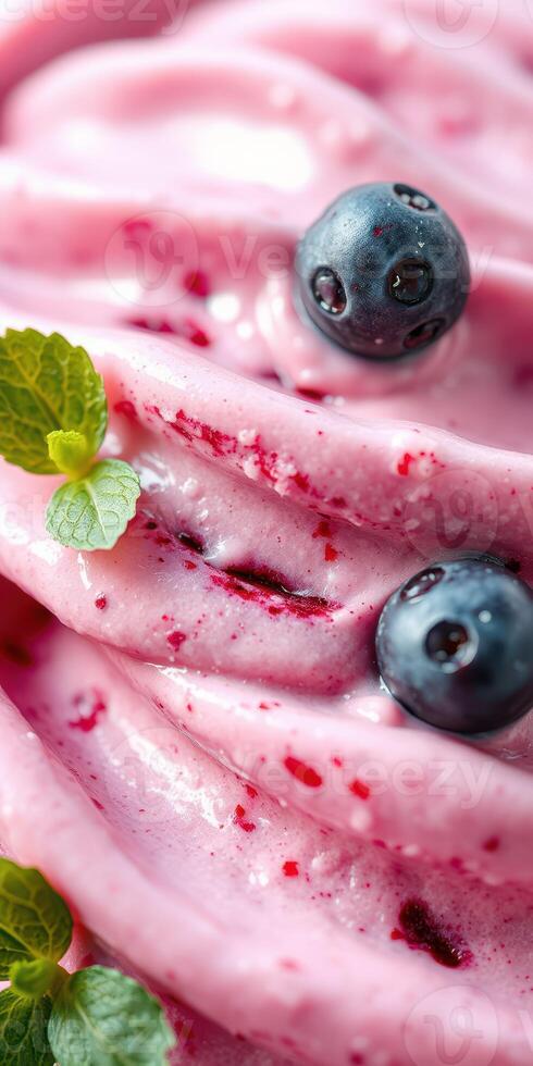 Delicious homemade berry yogurt with fresh blueberries and mint leaves served in a bowl photo
