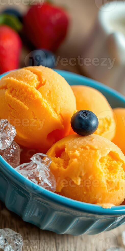 Enjoying delicious mango sorbet served with ice and fresh berries in a vibrant bowl photo