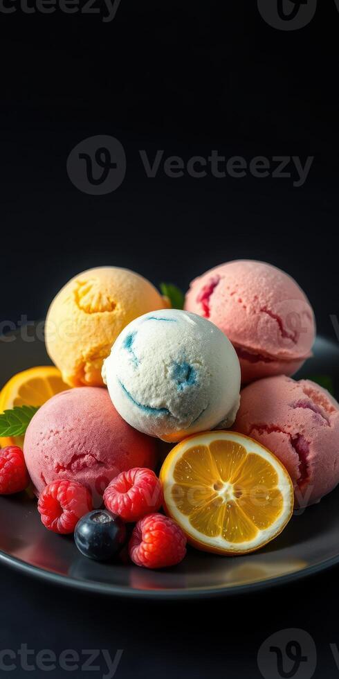 Colorful scoops of ice cream with fresh fruit on a black plate create a delightful dessert arrangement photo