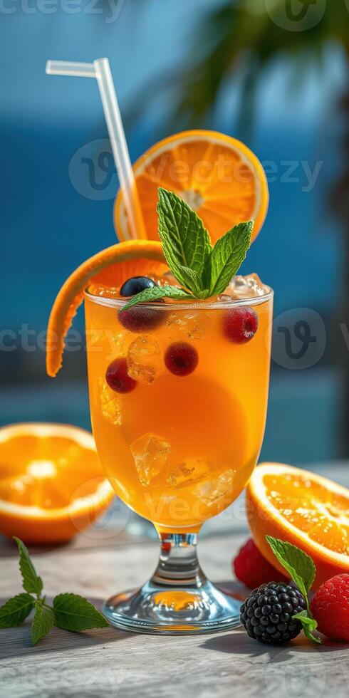Refreshing citrus cocktail served with fresh berries at a beachside setting during sunset photo