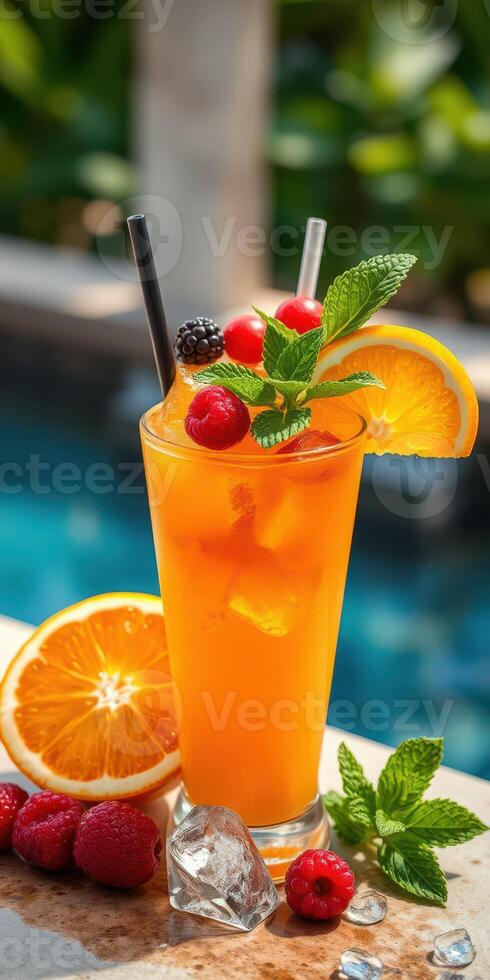 Refreshing tropical cocktail with fresh fruit garnishes by the poolside on a sunny day photo