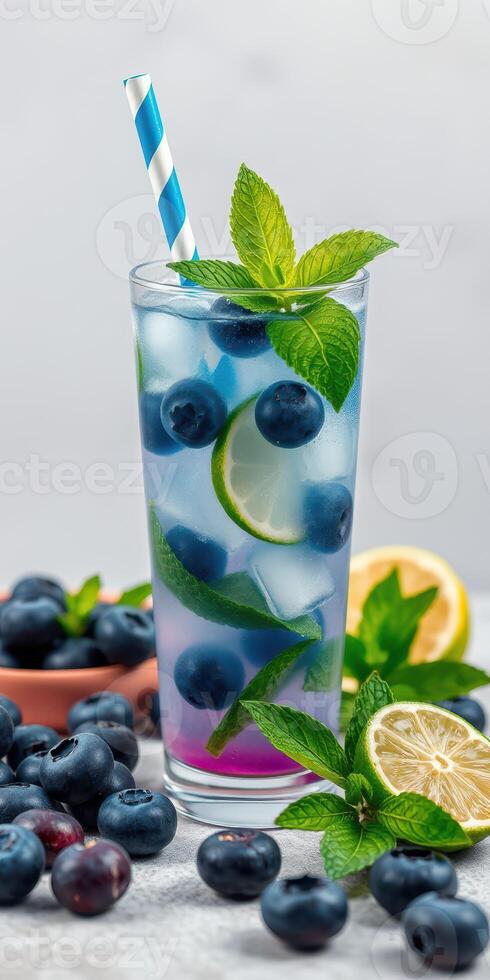 Refreshing blueberry lime drink garnished with mint leaves and served with fresh blueberries photo