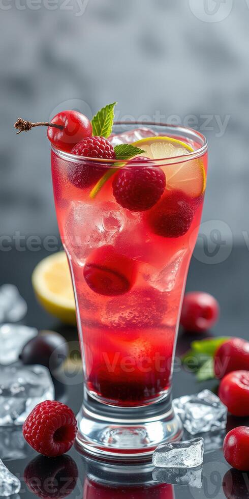 Refreshing berry cocktail with ice garnished with cherries and mint leaves on a dark background photo