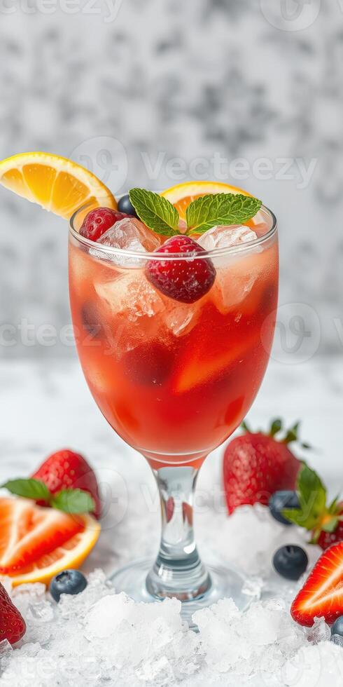 Refreshing summer cocktail with berries and citrus served over ice photo