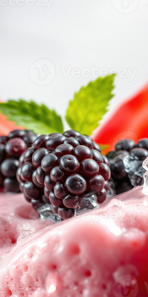 Fresh blackberries and mint on a vibrant smoothie with ice cubes at a bright kitchen setting photo