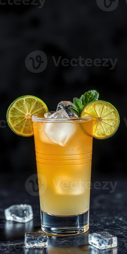 Refreshing citrus cocktail garnished with lime slices and mint leaves in a glass with ice cubes photo