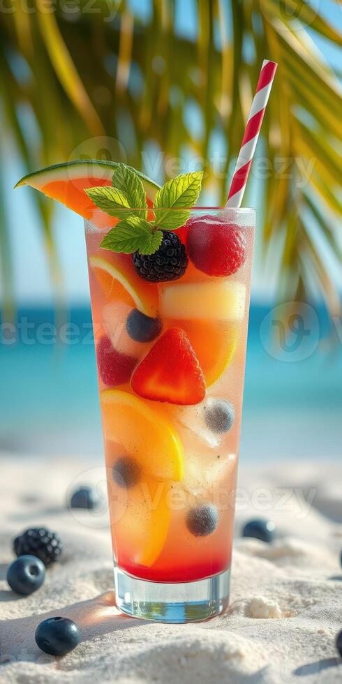Refreshing fruit cocktail served on a sunny beach with palm trees in the background photo