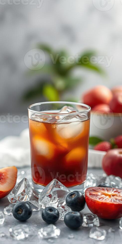 Refreshing cocktail served over ice with fresh fruit accents in a well-lit setting photo