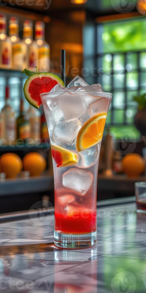 Refreshing fruit cocktail served with ice, garnished with watermelon and orange in a vibrant bar setting photo