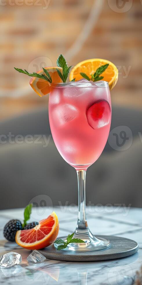 Colorful cocktail garnished with fresh fruit sits on a marble table in a stylish bar setting photo