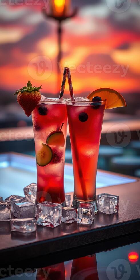 Colorful summer cocktails served with fresh fruits against a beautiful sunset background photo