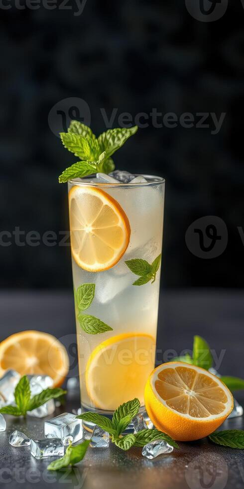 Refreshing lemonade drink garnished with mint leaves and lemon slices on a dark background photo